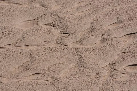 Closeup sand pattern of a beach in the summer Stock Photos