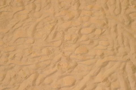 Closeup of sand pattern of a beach in the summer Stock Photos
