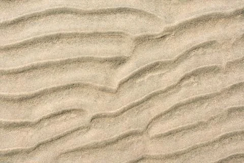 Closeup of sand pattern of a beach in the summer Stock Photos