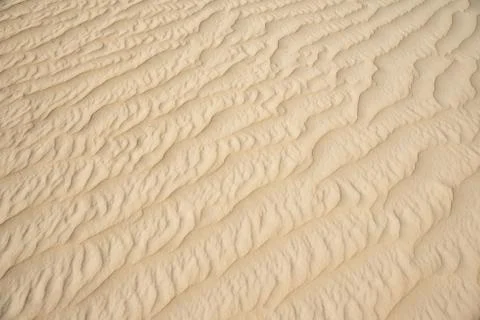 Closeup of sand pattern of beach in summer Stock Photos
