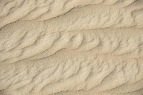 Closeup of sand pattern of beach in summer Stock Photos