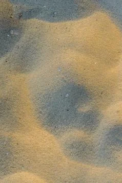 Closeup of sand pattern of a beach in the summer Stock Photos