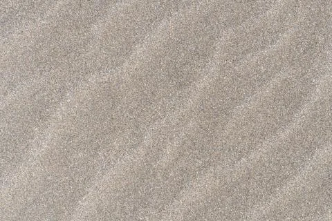 Closeup of sand pattern of a beach in the sunny day Stock Photos