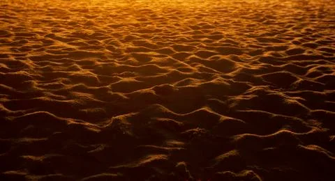 Closeup of sand pattern of a beach in the sunset. Stock-Fotos