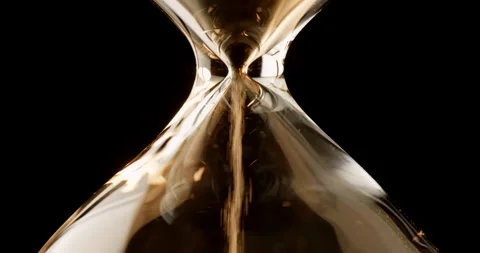 Closeup of sand timer clock with sand flowing from through hourglass. Stock Footage 276141947