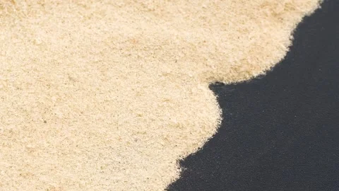 Closeup of sand transition blowing over black abstract background in slow motion Video stock 261938004