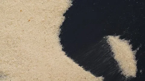 Closeup of sand transition blowing over black abstract background in slow motion Video stock 263410412