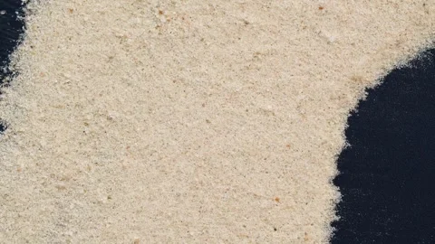 Closeup of sand transition blowing over black abstract background in slow motion Stock Footage 276204447