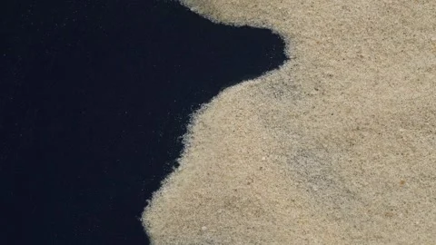 Closeup of sand transition blowing over black abstract background in slow motion Stock Footage 319516985