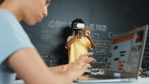 Closeup of school girl hand coding program while student using VR. Edification. Stock-Fotos