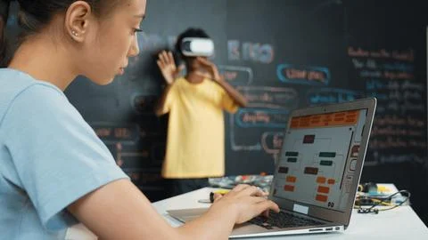 Closeup of school girl hand coding program while student using VR. Edification. Stock Photos
