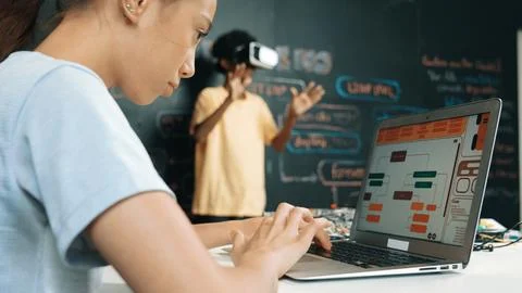 Closeup of school girl hand coding program while student using VR. Edification. Stockfoto's