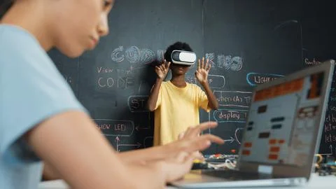 Closeup of school girl hand coding program while student using VR. Edification. Stock Photos