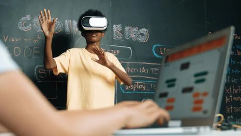 Closeup of school girl hand coding program while student using VR. Edification. Stockfoto's