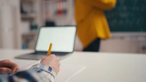 Closeup of school pupil writing the solution to problem, algebra lesson in class Stock Footage 250334078