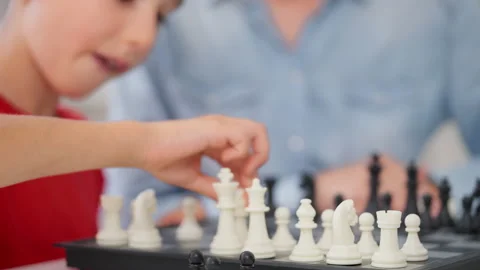 Closeup of schoolboy playing chess with his mom, improving critical thinking Stock Footage 230921894
