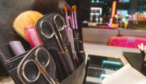 Closeup of scissors combs and make tool in a salon holster pouch .sets of mak Foto stock
