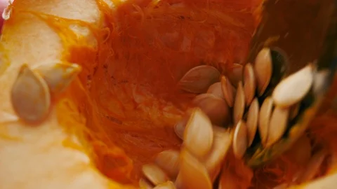 Closeup Scooping Seeds from an Acorn Squash Stock Footage 125828199
