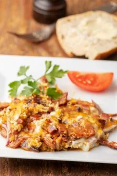 Closeup of scrambled eggs with bacon Stock Photos