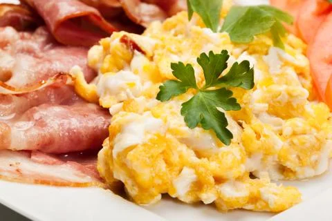Closeup of scrambled eggs with bacon. selective focus. Stock Photos