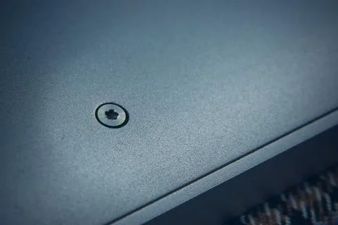 Closeup of a screw fixed on a matte surface, showcasing its design and details Stock Photos