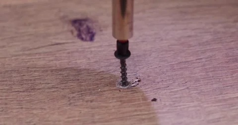 A closeup of a screw on a wooden surface, showcasing its details and Stock Footage 297952762