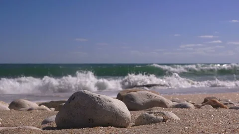 Closeup of sea pebbles against the backdrop of a stormy sea Stock Footage 90672613