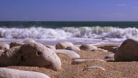 Closeup of sea pebbles against the backdrop of a stormy sea Stock Footage 90673204