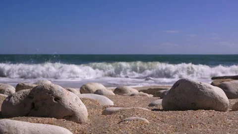 Closeup of sea pebbles against the backdrop of a stormy sea Stock-Footage 90673612