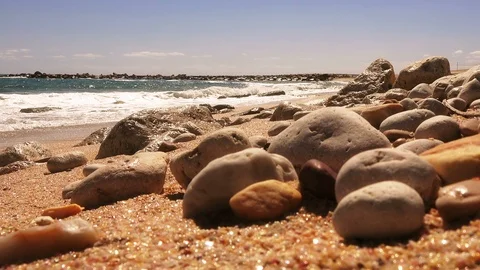 Closeup of sea pebbles against the backdrop of a stormy sea Stock Footage 90678942