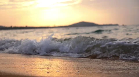 Closeup of Sea Waves on Sandy Beach at Sunset. Slow Motion. Stock Footage
