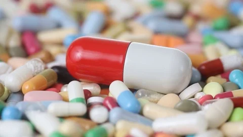 Closeup seamless loop of big pill among many colorful pills Stock Footage 123002342