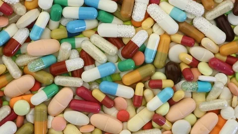 Closeup seamless loop of medication pills spinning Video stock 95913311