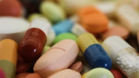 Closeup seamless loop of pills spinning through view Stock Footage 95476939