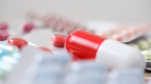 Closeup seamless loop of rotating pile of medicine with big pill Stock Footage 124121854