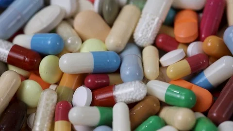 Closeup seamless loop of rotating pile of medication pills Video stock 124636380