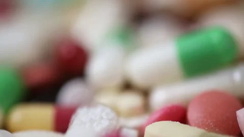 Closeup seamless loop of rotating pile of colourful pills with shallow dept.. Stock Footage 288107159