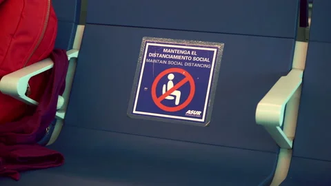 Closeup a seat with Do not sit sign due to coronavirus and social distancing Stock Footage 171400494