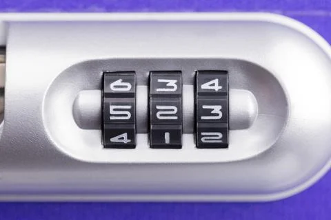 Closeup of a security padlock with three numbers on a violet suitcase ready for Foto stock