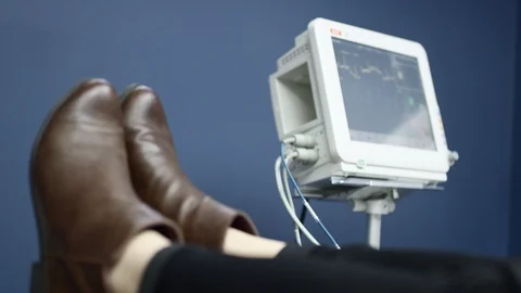 Closeup of sedated patient's feet as they lay down with monitor in background Stock Footage 113721053