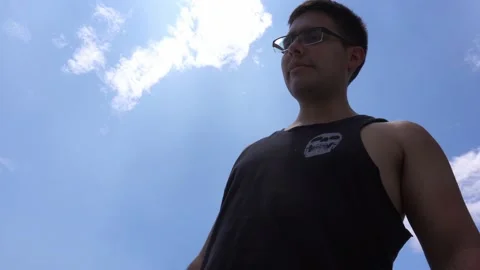 Closeup seen from below of a man with glasses with a bottle of whiskey in his Stock Footage 172270867