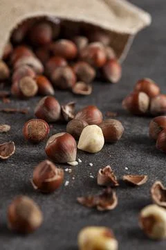 Closeup selective focus image of hazelnuts in shells scattered from a vintage Stock Photos