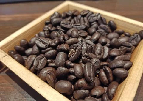 A Closeup selective focus Picture of Coffee Bean places in a Wooden Box Stock Photos