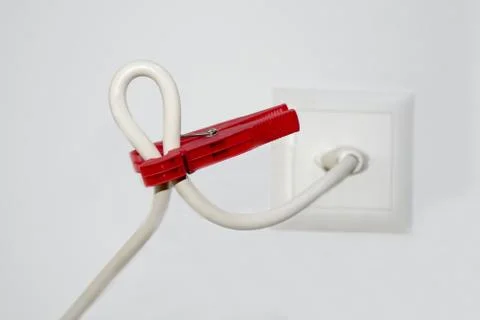 Closeup selective focus shot of a white cable and a red  clothespin 스톡 사진