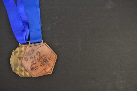 A Closeup selective focus view of a Bronze running medals against a black backgr Stock Photos