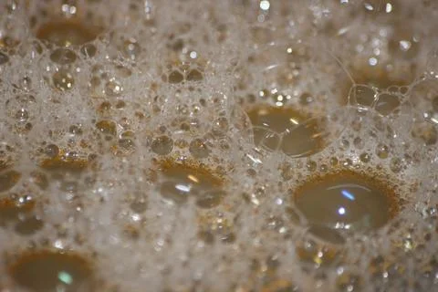 Closeup selective view of Foam and soap bubbles over water. 스톡 사진