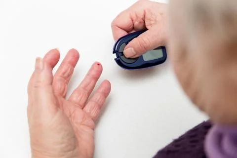 Closeup of senior hands with glucometer 스톡 사진