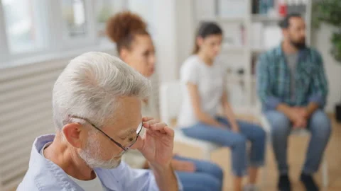 Closeup of senior man sharing his problem with support group participants, help Stock Footage 232295842