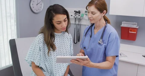 Closeup of senior nurse using tablet computer to share test results with patient Stock Footage 94456974