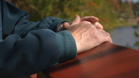 Closeup of senior old man hand against beautiful nature forest river background 스톡 동영상 89702401
